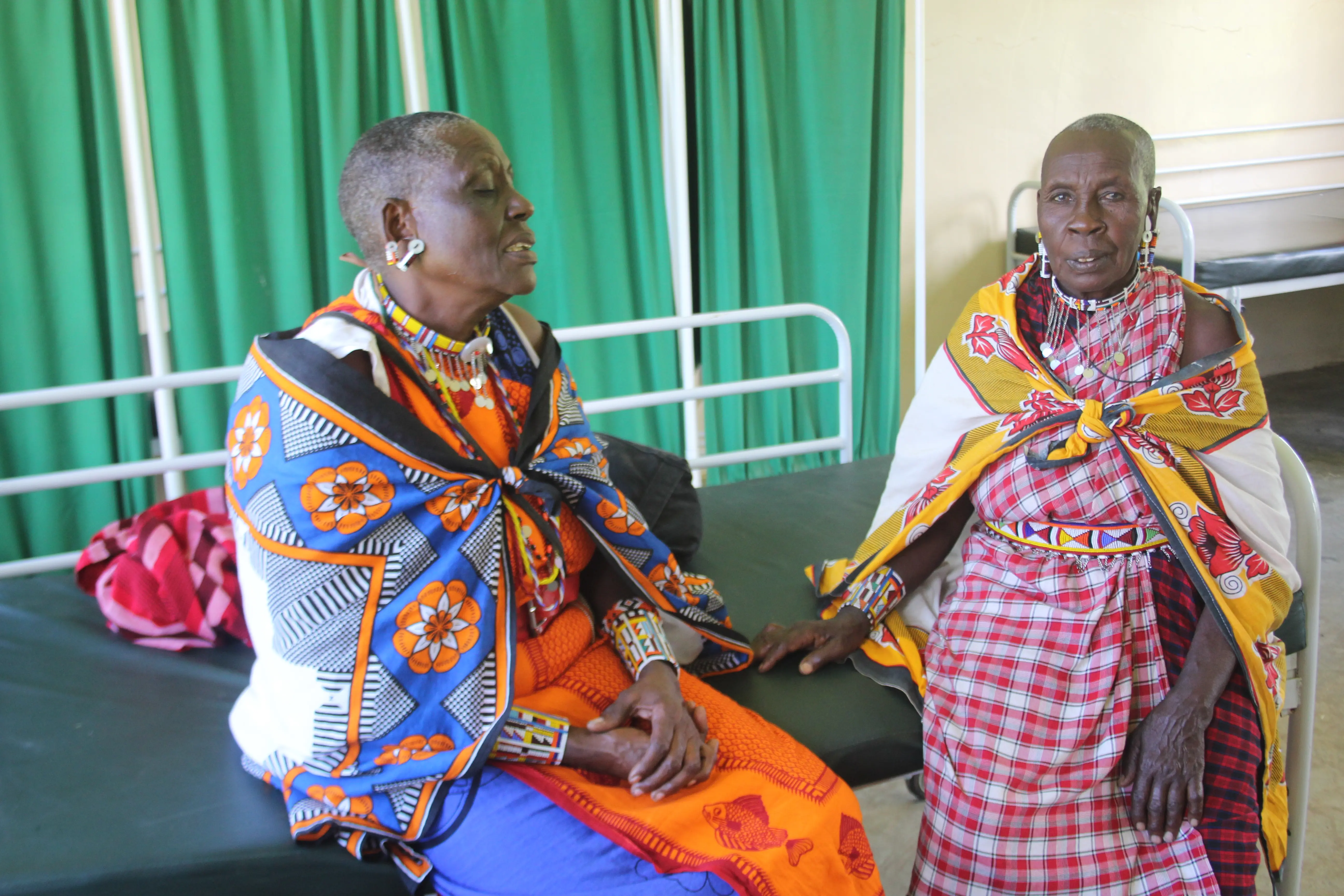 Mama Paulina chatting with a community members at AIC Olasiti Dispensary