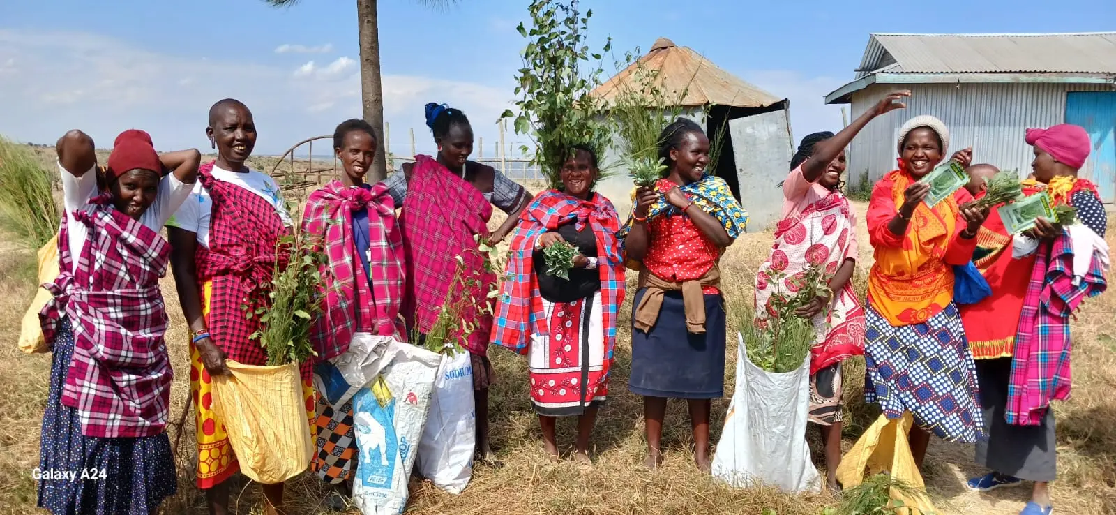 Happ and exited project caregivers after receiving tree and vegetable seedlings from the project